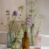 Pakke med 10 pastelfarvede glasvaser til små buketter, enkelte blomster og dekorativ bordpynt.